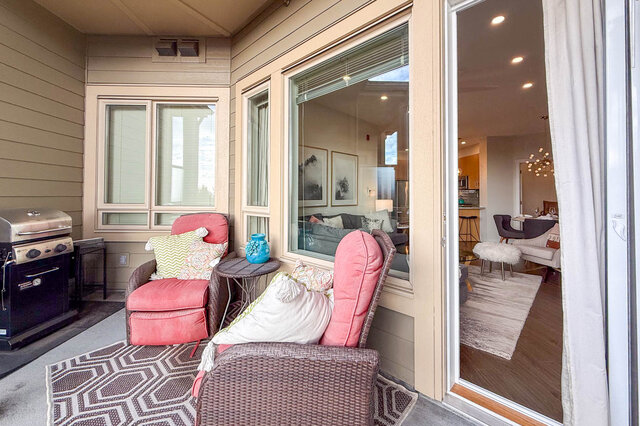 Spacious patio with cozy seating, outdoor grill, and sliding glass door leading to living room. - 526-119 West 22nd Street, North Vancouver