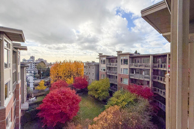 Bright balcony with colorful autumn foliage and city views. - 526-119 West 22nd Street, North Vancouver