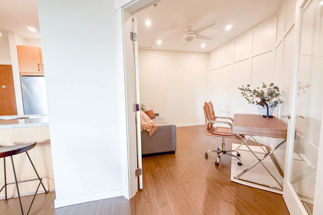 Spacious living room with hardwood floors, modern furniture, and a cozy corner. - 526-119 West 22nd Street, North Vancouver