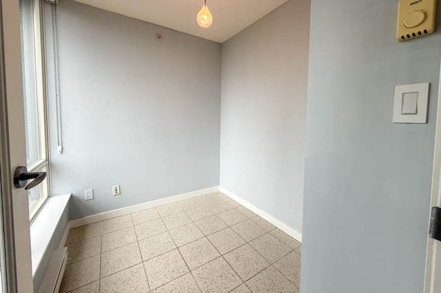 Den with light gray walls, white baseboards, and terrazzo flooring. - 1011- 939 Expo Blvd., Vancouver Downtown