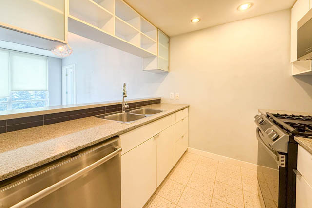 Bright kitchen with granite countertops, stainless steel appliances, and a city view. - 1011- 939 Expo Blvd., Vancouver Downtown