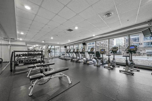 Spacious gym with treadmills, dumbbells, and city views. - 1011- 939 Expo Blvd., Vancouver Downtown