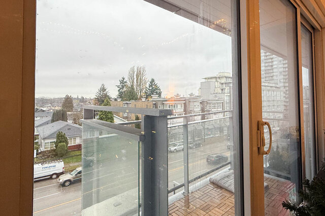 Bright balcony with city view and modern railings, perfect for enjoying the Vancouver East Side ambiance. - 407-2435 Kingsway, Vancouver East Side