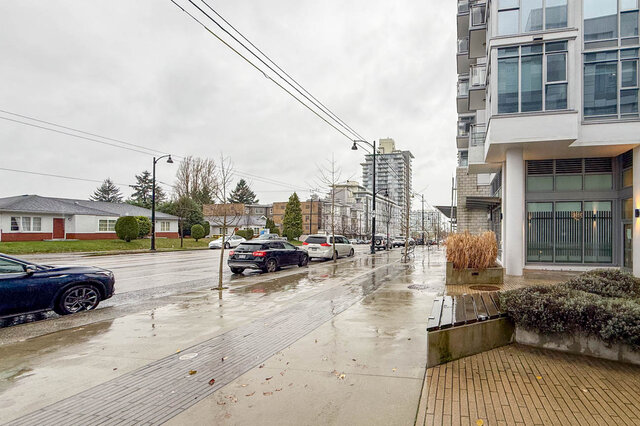 Spacious 1-bedroom + den condo with modern furnishings and a view of the city skyline. - 407-2435 Kingsway, Vancouver East Side