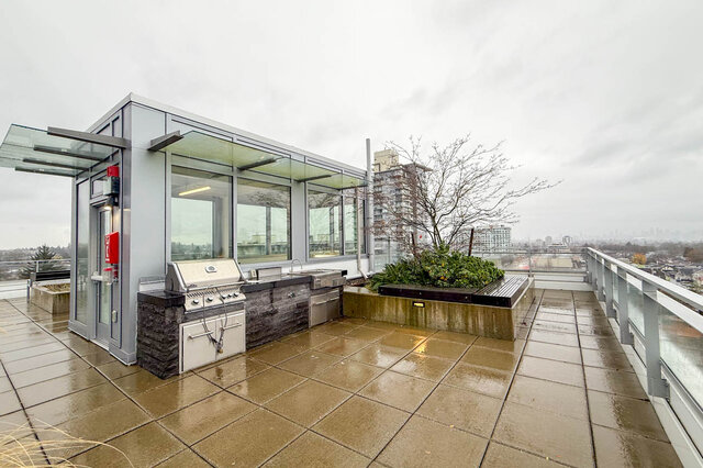 Spacious rooftop patio with a modern grill and city view. - 407-2435 Kingsway, Vancouver East Side