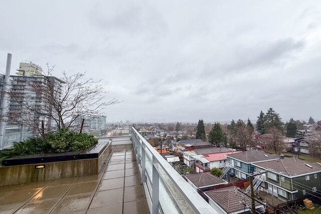 Spacious balcony with city view and wet tiles, perfect for enjoying the Vancouver East Side ambiance. - 407-2435 Kingsway, Vancouver East Side