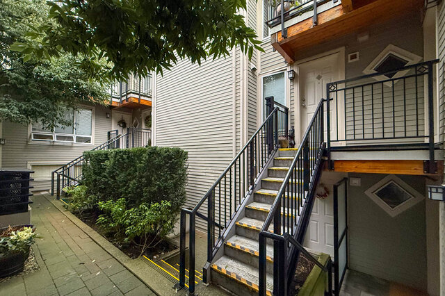 Furnished 1-bedroom + den condo with modern railings and steps leading to a balcony. - 304-3637 West 17th Ave, Vancouver West Side