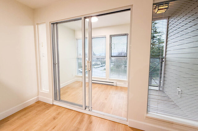 Spacious den with hardwood floors, large windows, and a city view. - 304-3637 West 17th Ave, Vancouver West Side