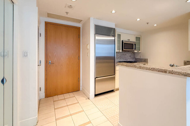 Modern kitchen with granite countertops and stainless steel appliances. - 706-499 Broughton, Vancouver Downtown