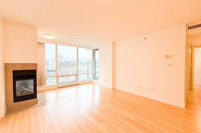 Spacious living room with hardwood floors, fireplace, and city view. - 706-499 Broughton, Vancouver Downtown