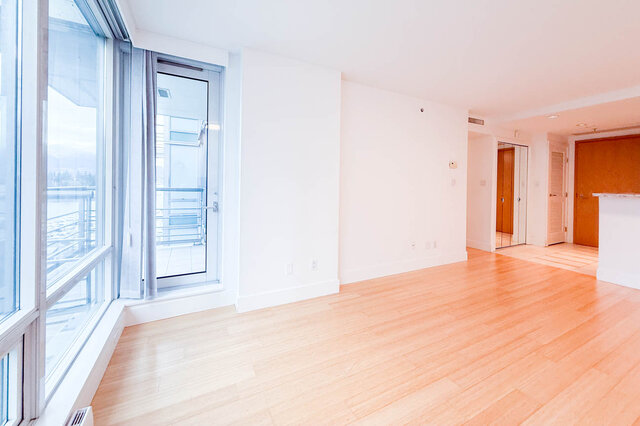 Spacious living room with hardwood floors, large windows, and a city view. - 706-499 Broughton, Vancouver Downtown