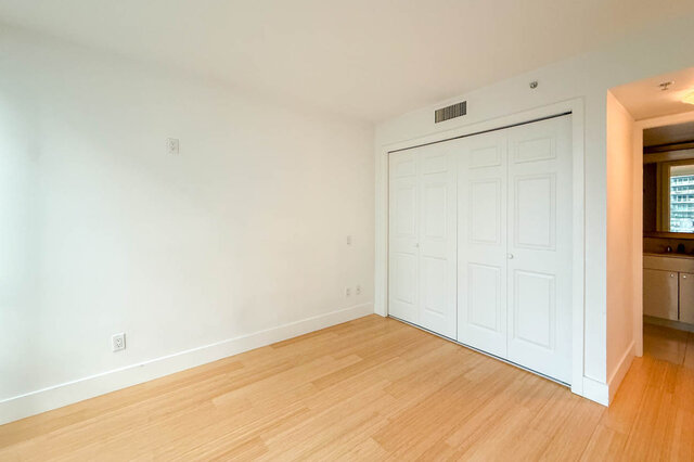 Spacious bedroom with hardwood floors and built-in closet, ready for furnishings. - 706-499 Broughton, Vancouver Downtown
