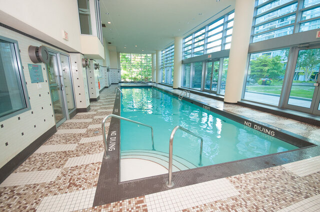 Spacious indoor pool with tiled floors and large windows offering a serene city view. - 706-499 Broughton, Vancouver Downtown