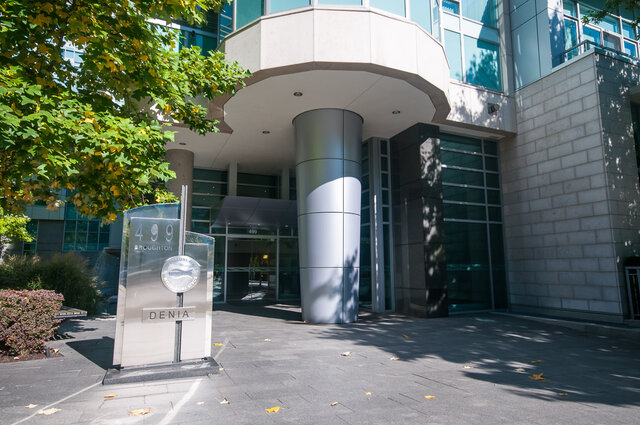 Spacious 2-bedroom condo with modern design, featuring a sleek glass entrance and a cozy outdoor patio. - 706-499 Broughton, Vancouver Downtown