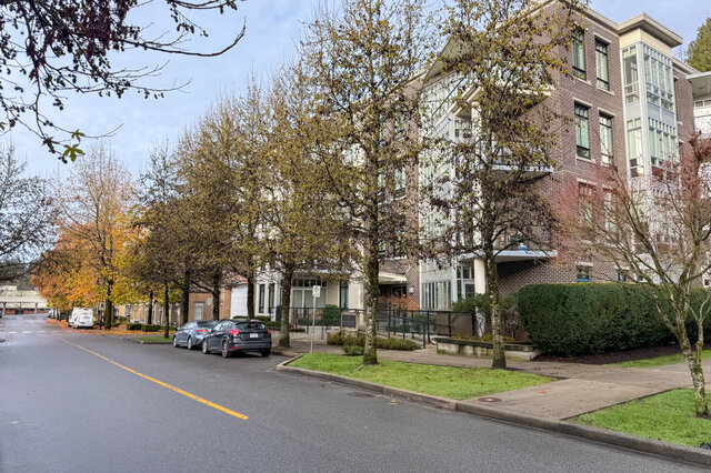Spacious 2-bedroom + den condo with modern furnishings, large windows, and a serene tree-lined street view. - 301-605 Clyde Ave, West Vancouver
