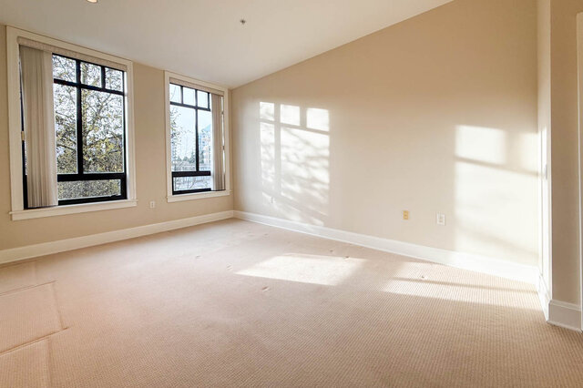 Spacious den with large windows and natural light, perfect for a cozy reading nook or home office. - 301-605 Clyde Ave, West Vancouver