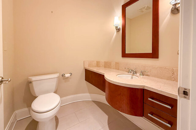 Spacious bathroom with marble countertops and a modern vanity. - 301-605 Clyde Ave, West Vancouver