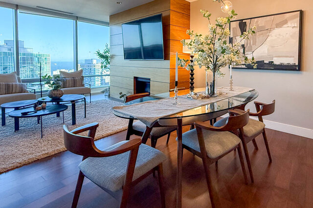 Spacious dining area with glass-top table and panoramic city views through floor-to-ceiling windows. - 3309-1111 Alberni Street, Vancouver Downtown