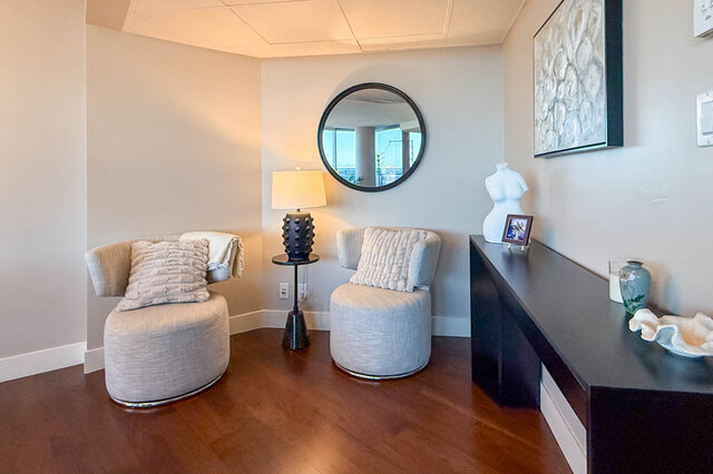 Cozy living space with plush armchairs and hardwood floors. - 3309-1111 Alberni Street, Vancouver Downtown