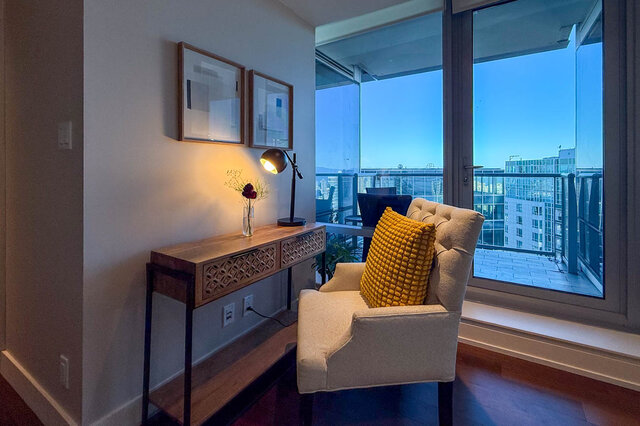Cozy living area with panoramic city views and warm hardwood flooring near balcony. - 3309-1111 Alberni Street, Vancouver Downtown
