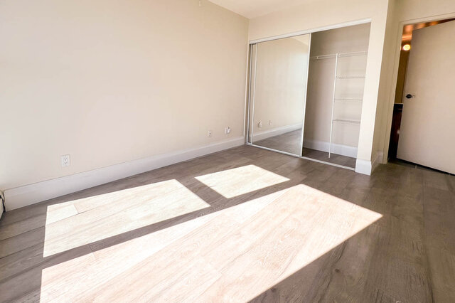 Spacious bedroom with hardwood floors and mirrored closet doors. - 2905-1009 Expo Boulevard, Vancouver Downtown
