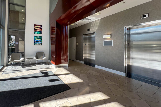 Modern elevator lobby with sleek stainless steel doors and contemporary art on the wall. - 2905-1009 Expo Boulevard, Vancouver Downtown