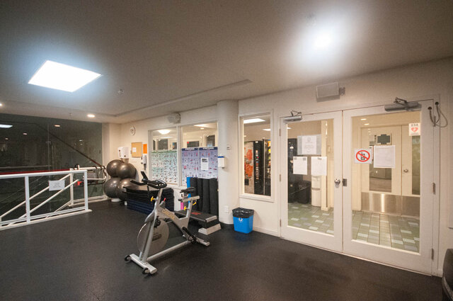 Spacious fitness room with exercise bikes, mirrors, and yoga mats, perfect for workout enthusiasts. - 2905-1009 Expo Boulevard, Vancouver Downtown