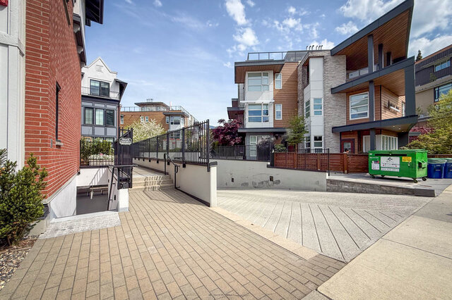 Modern kitchen with light wood cabinets, stainless steel appliances, and a central island. - 210-2060 Curling Road, North Vancouver