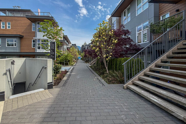 Spacious bathroom with marble tiles and modern shower fixtures. - 210-2060 Curling Road, North Vancouver