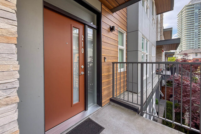 Spacious balcony with modern furnishings and city view. - 210-2060 Curling Road, North Vancouver