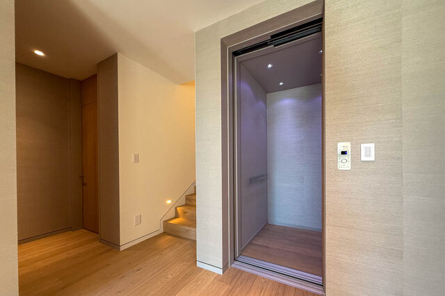 Elevator lobby with hardwood floors and modern glass elevator interior. - 2390 Westhill Drive, West Vancouver