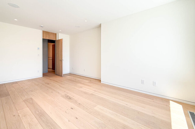 Spacious open room with light hardwood floors and white walls. - 2390 Westhill Drive, West Vancouver