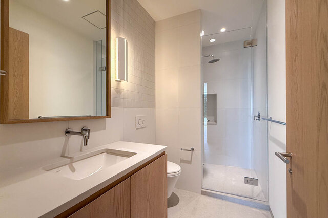 Bathroom with light wood vanity and glass shower enclosure. - 2390 Westhill Drive, West Vancouver