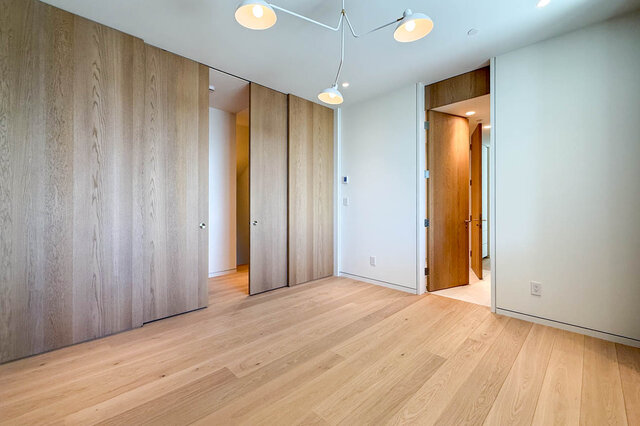 Spacious hallway with light hardwood floors and wooden sliding doors. - 2390 Westhill Drive, West Vancouver