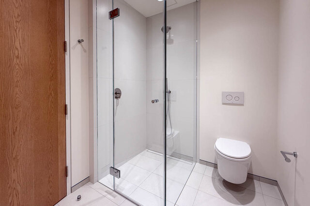 Bathroom with glass-enclosed shower and wall-mounted toilet. - 2390 Westhill Drive, West Vancouver