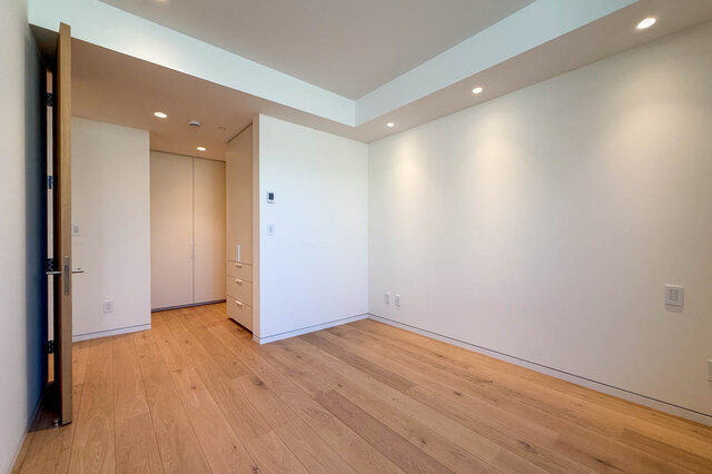 Spacious bedroom with light hardwood floors and recessed ceiling lights. - 2390 Westhill Drive, West Vancouver