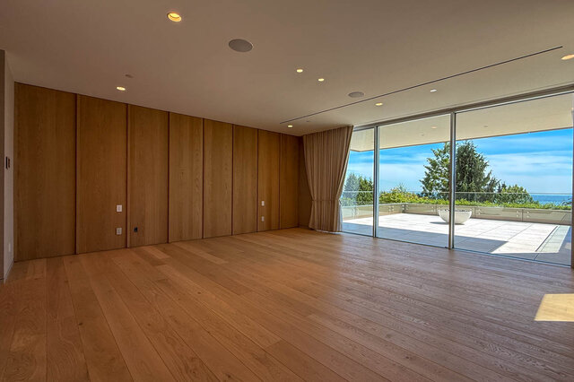 Spacious living room with hardwood floors and ocean view through sliding glass doors. - 2390 Westhill Drive, West Vancouver
