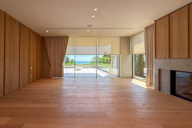 Spacious living room with hardwood floors and ocean view through large windows. - 2390 Westhill Drive, West Vancouver