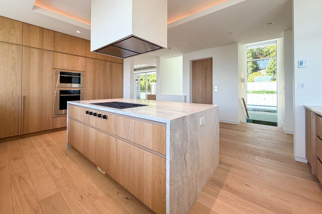 Modern kitchen with light wood cabinets and quartz countertops. - 2390 Westhill Drive, West Vancouver