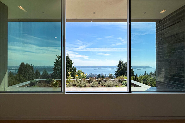 Living room with floor-to-ceiling windows overlooking city and water. - 2390 Westhill Drive, West Vancouver