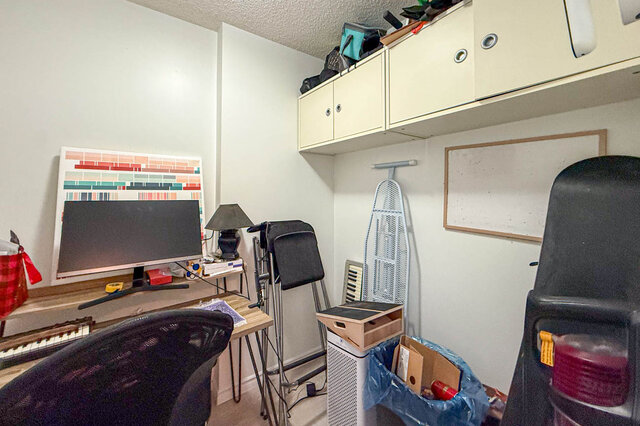 Furnished den with computer desk, overhead cabinets, and ironing board. - 501-550 Taylor Street, Vancouver Downtown