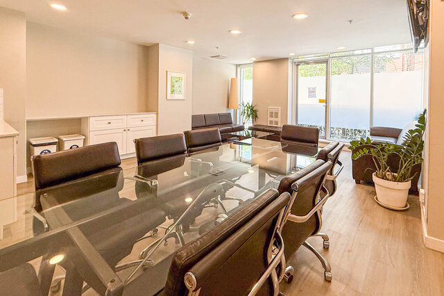 Modern dining area with glass-top table and sleek leather chairs on hardwood floors. - 501-550 Taylor Street, Vancouver Downtown