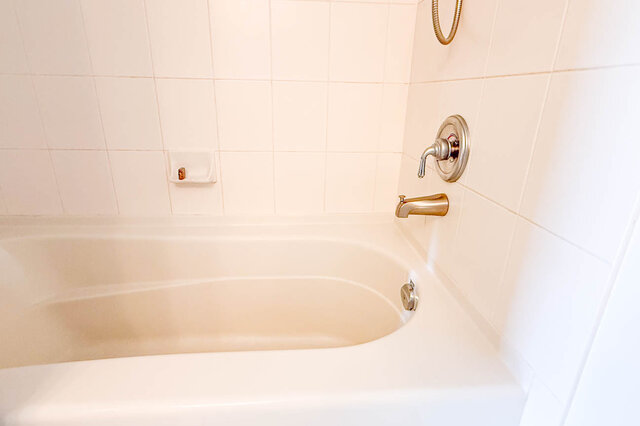 Bright bathroom with modern sink, green countertop, and white towel rack. - 1805-4388 Buchanan Street, Burnaby