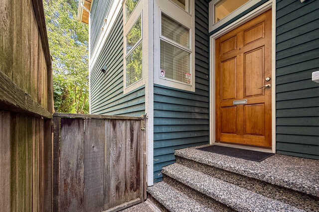 Spacious entryway with wooden gate and driveway access to duplex entrance. - 3443 West 6th Ave, Vancouver West Side