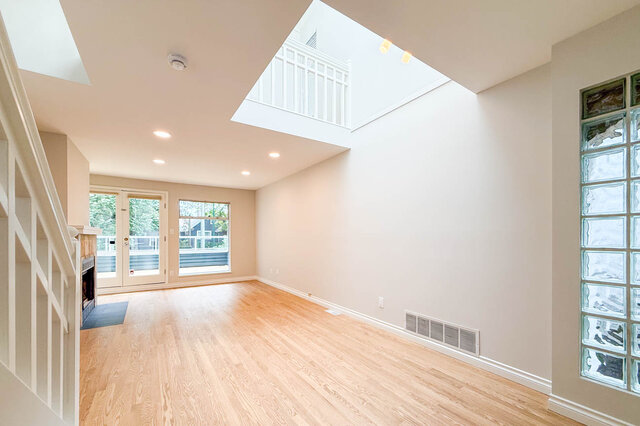 Spacious living area with hardwood floors and stone fireplace. - 3443 West 6th Ave, Vancouver West Side