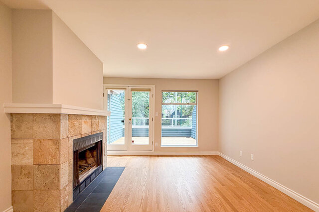 Spacious living room with hardwood floors and stone fireplace. - 3443 West 6th Ave, Vancouver West Side