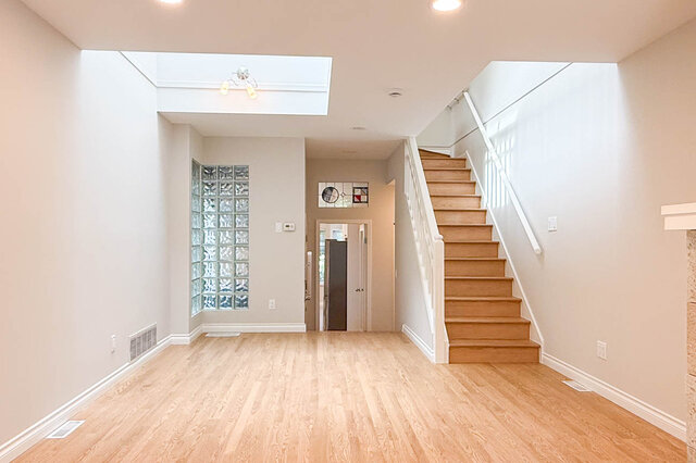 Bright hallway with tiled flooring and stained glass transom window. - 3443 West 6th Ave, Vancouver West Side