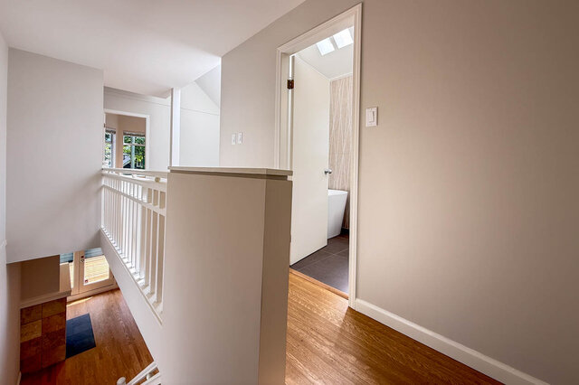 Bright den with large windows and tile flooring, showcasing greenery outside. - 3443 West 6th Ave, Vancouver West Side