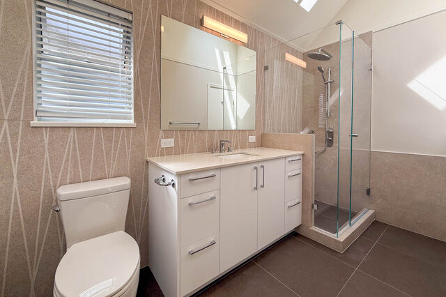 Modern bathroom with freestanding tub and sleek white vanity countertop. - 3443 West 6th Ave, Vancouver West Side