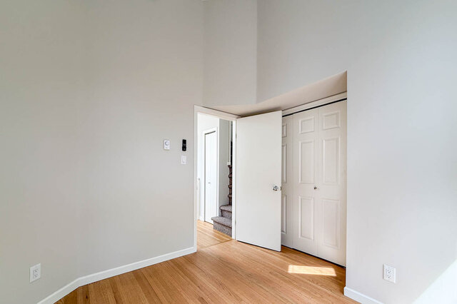 Spacious bedroom with hardwood floors and a built-in sliding-door closet. - 3443 West 6th Ave, Vancouver West Side